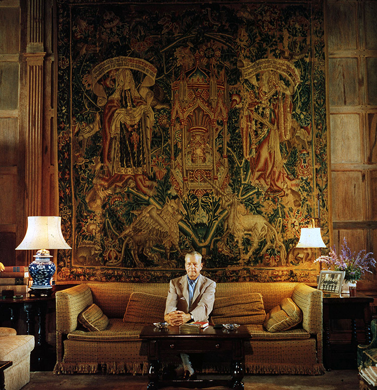 Harold S. Vanderbilt in front of a magnificent tapestry in his home Manalapan, at Lantana, Palm Beach, 1956.