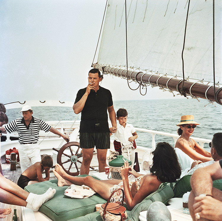 Henry B. Cabot Jr. (standing, centre) with his son Henry Bromfield Cabot III and their host Barclay (Buzzy) H. Warburton III (in striped shirt) aboard the brigantine Black Pearl, circa 1959. They are sailing off North Shore, Boston, around Manchester and Marblehead harbors, Essex County, Massachusetts.