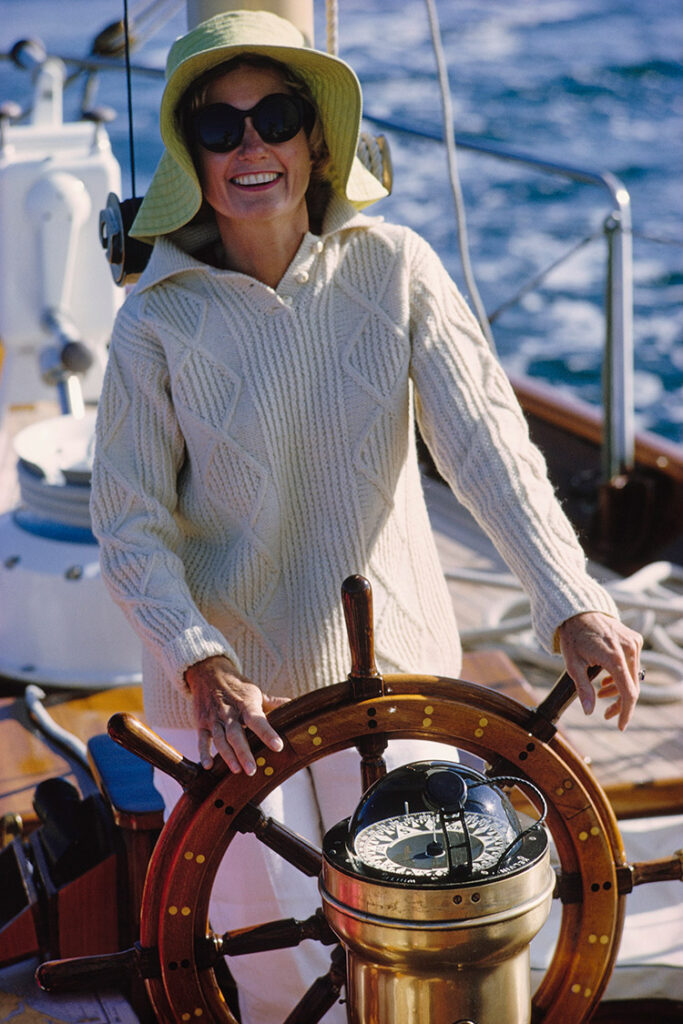 Mrs. Blaffer Hudson at the wheel of Walter Gubelmann’s yacht Windago, 1965.